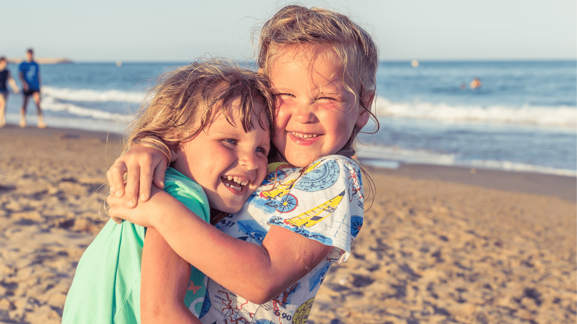 two-kids-hugging-on-gold-coast-beach